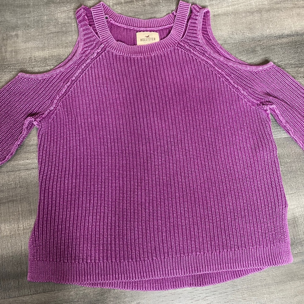 Knit purple sweater with shoulder cut outs.